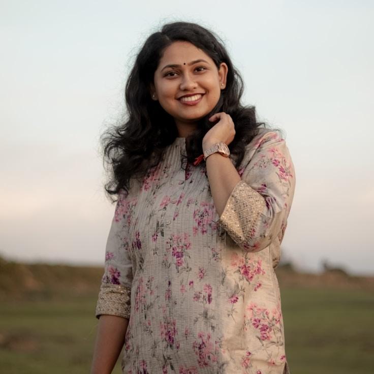 Kaveri Mehta, Lead Design Curator at Quiet Bridge Ledger, reviewing corporate floral arrangements